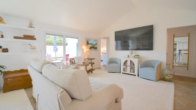 living area featuring vaulted ceiling and light tile patterned floors