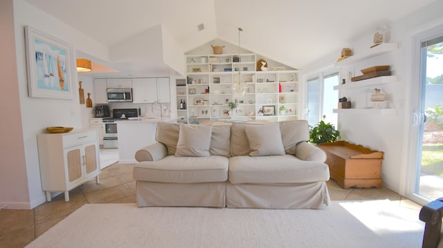 living room with vaulted ceiling and light tile patterned flooring