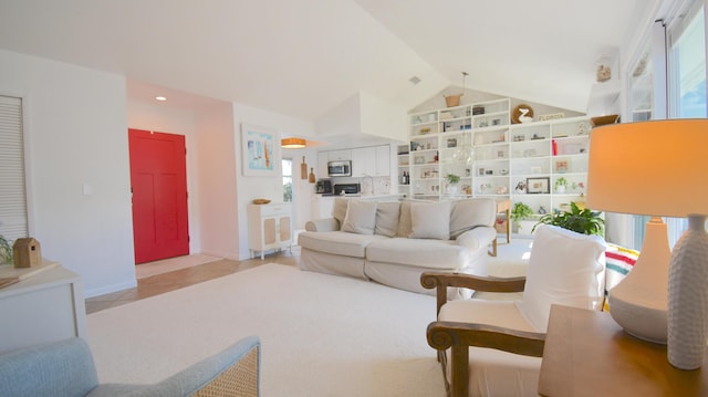 living room with vaulted ceiling, light tile patterned floors, baseboards, and built in features