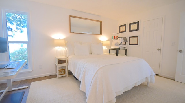 bedroom with multiple windows and baseboards