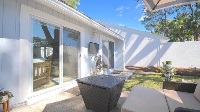 view of patio featuring fence and an outdoor hangout area