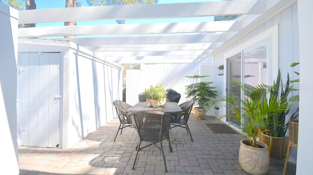 view of patio featuring outdoor dining area and a pergola