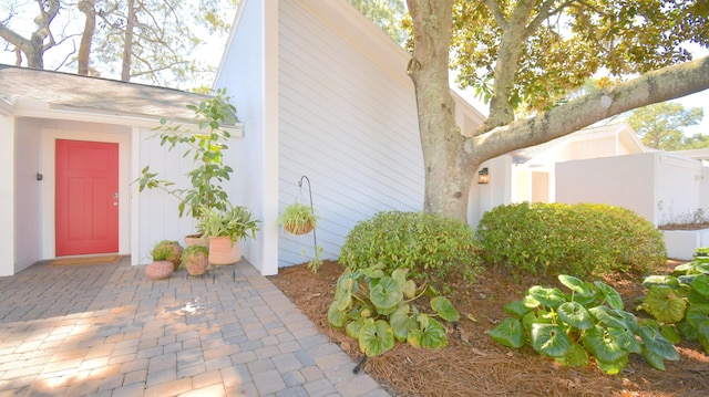 view of home's exterior featuring a shingled roof and a patio