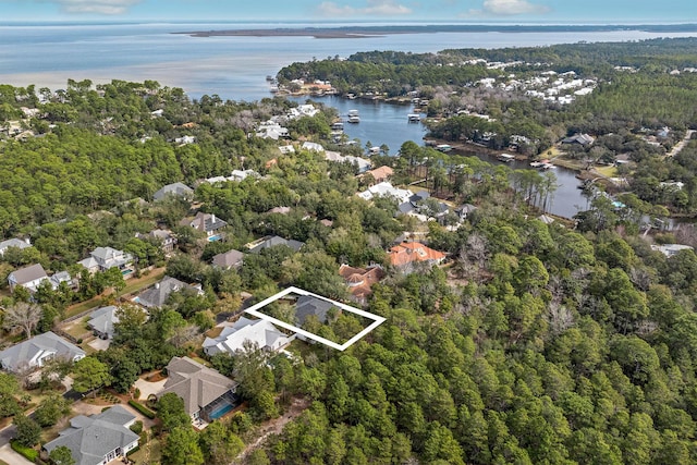 aerial view featuring a forest view, a water view, and a residential view