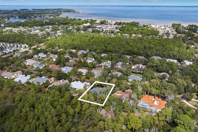 birds eye view of property with a water view and a residential view