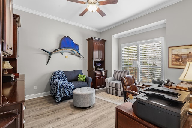 office space with baseboards, a ceiling fan, light wood-type flooring, and ornamental molding