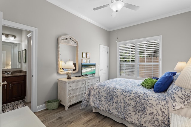 bedroom with a ceiling fan, baseboards, ensuite bath, ornamental molding, and light wood-style floors