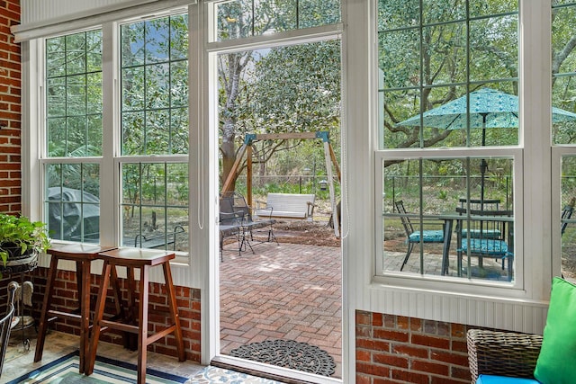 entryway featuring brick floor and brick wall