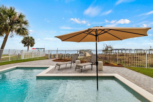 view of swimming pool featuring a patio area, fence, and a fenced in pool