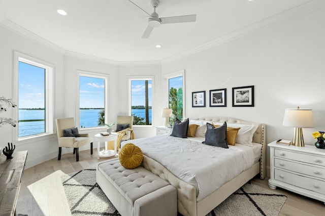 bedroom featuring multiple windows, crown molding, and wood finished floors