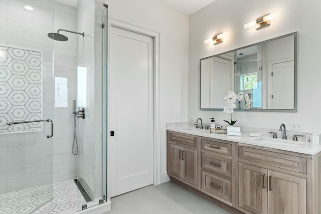 bathroom with double vanity, tile patterned flooring, a sink, and a shower stall