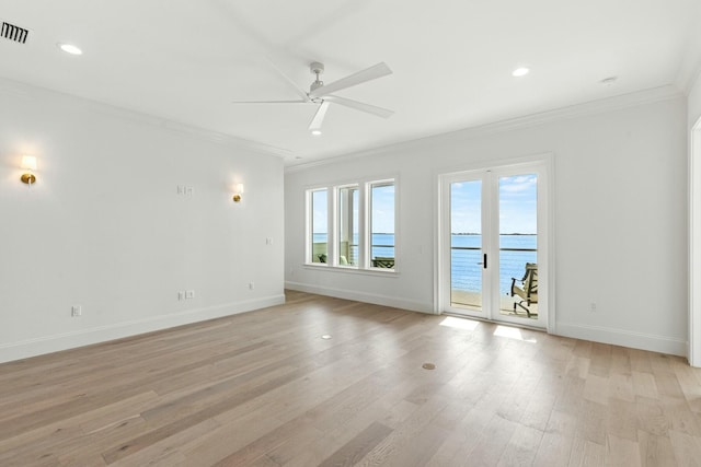 unfurnished room featuring visible vents, baseboards, light wood-style flooring, ceiling fan, and ornamental molding