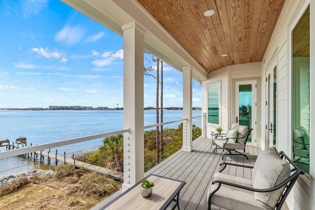 sunroom / solarium with wooden ceiling and a water view