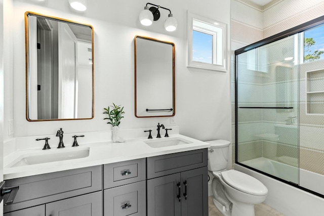 full bath featuring a healthy amount of sunlight, toilet, and a sink