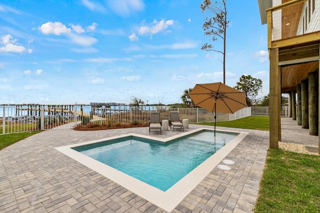 view of swimming pool featuring a fenced in pool, a patio area, a yard, and a fenced backyard