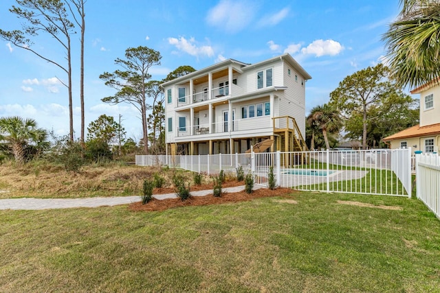 coastal inspired home featuring fence private yard, a balcony, stairs, a fenced in pool, and a front yard