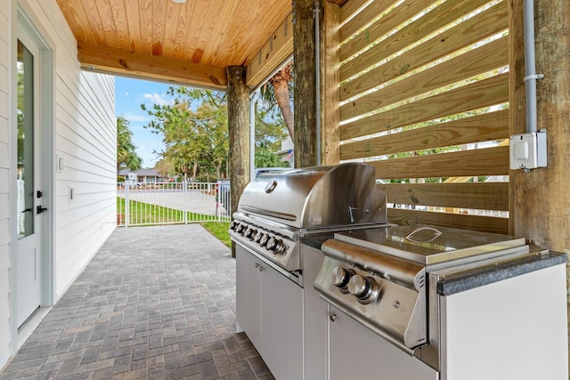 view of patio / terrace featuring area for grilling, a grill, and fence