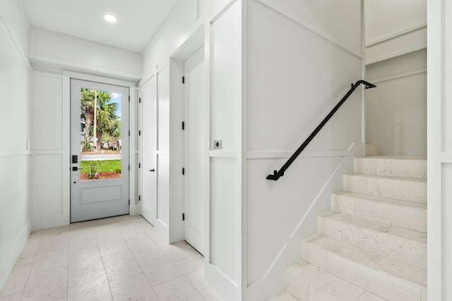 entrance foyer with stairway and recessed lighting