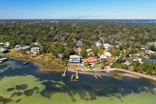 drone / aerial view with a water view and a view of trees