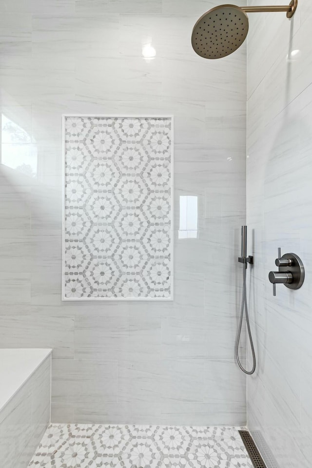 full bathroom with tiled shower