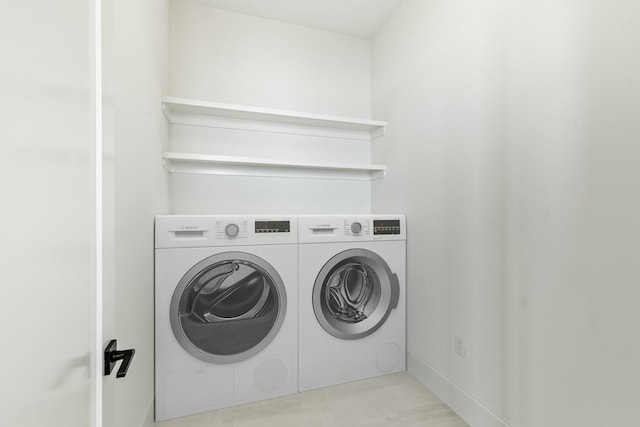 washroom with washing machine and dryer and laundry area