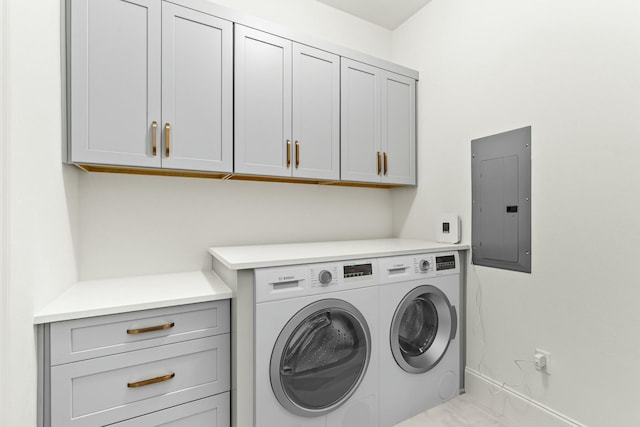 laundry room featuring electric panel, cabinet space, and washing machine and clothes dryer