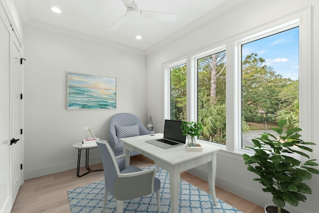 office area with a ceiling fan, light wood-style flooring, baseboards, and crown molding