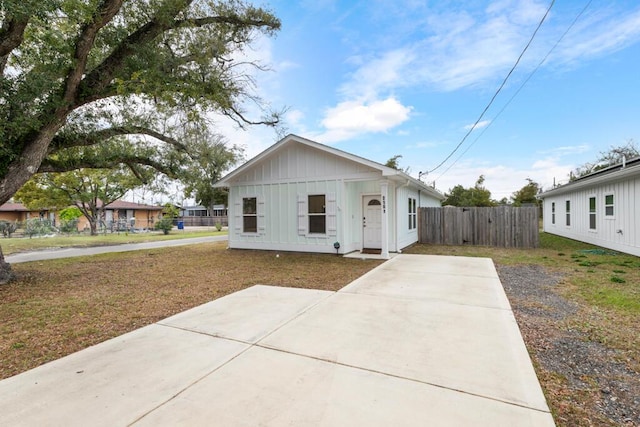 view of front facade with board and batten siding and fence