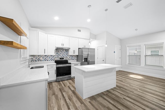 kitchen with appliances with stainless steel finishes, pendant lighting, white cabinetry, and open shelves