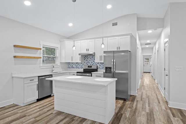 kitchen featuring white cabinets, open shelves, stainless steel appliances, and light countertops