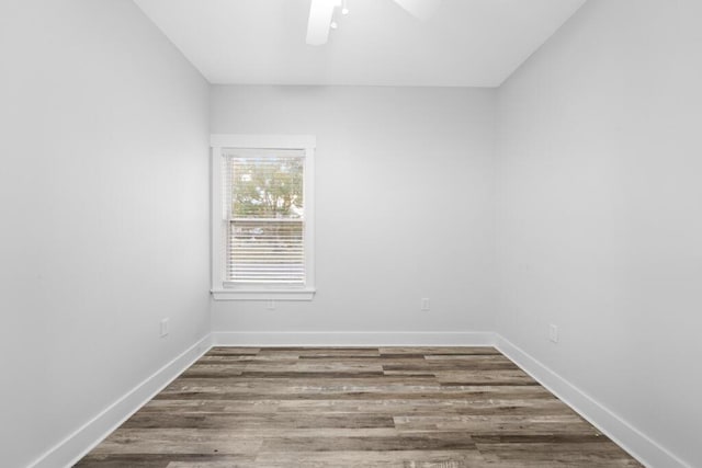 unfurnished room with ceiling fan, baseboards, and wood finished floors