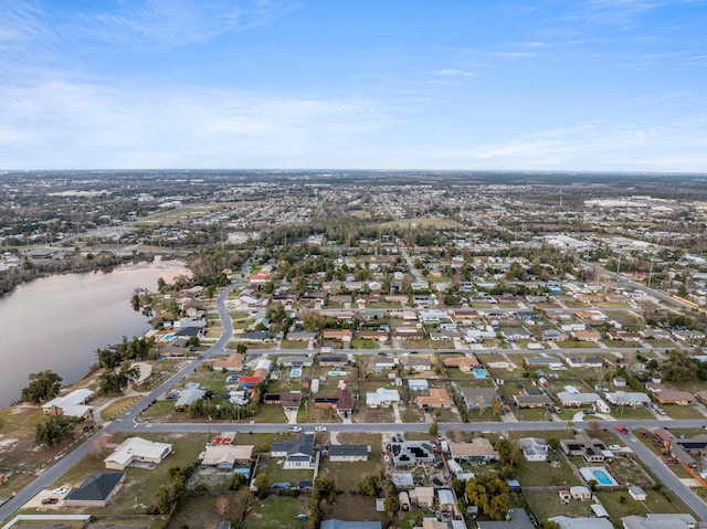 drone / aerial view featuring a water view and a residential view