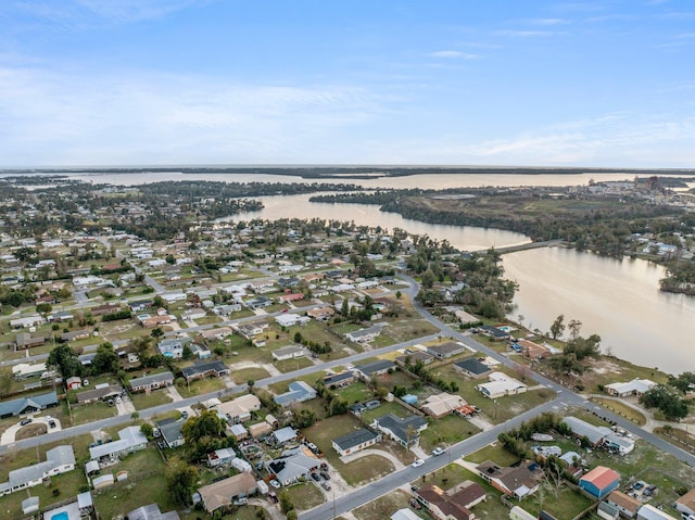 drone / aerial view featuring a residential view and a water view