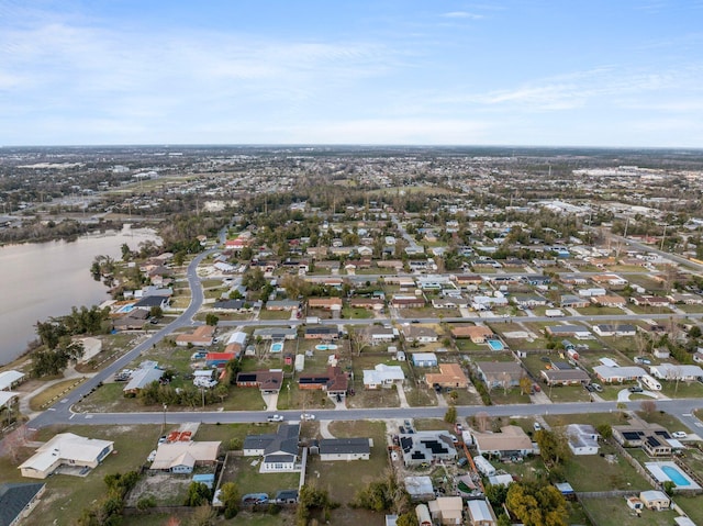 drone / aerial view featuring a water view and a residential view