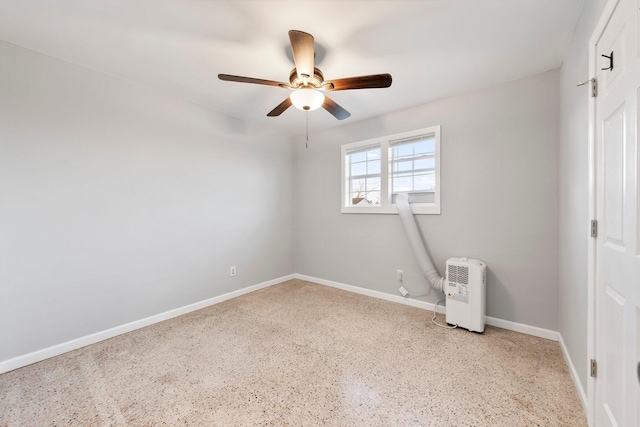 unfurnished bedroom with light speckled floor, ceiling fan, and baseboards