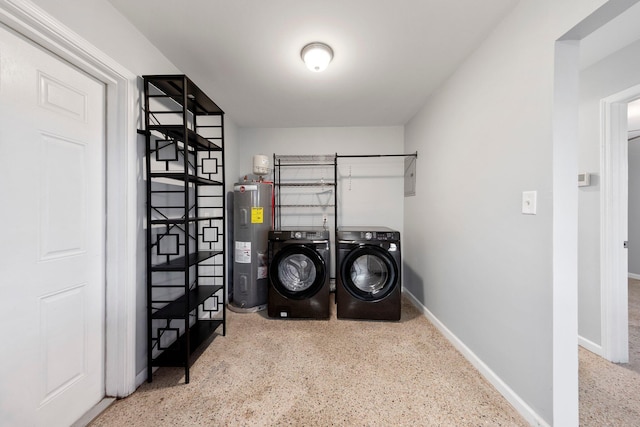 laundry area featuring independent washer and dryer, baseboards, laundry area, and electric water heater