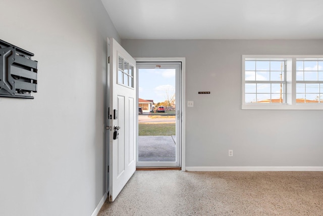 entryway with baseboards and light speckled floor