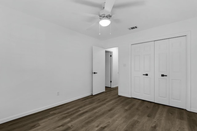 unfurnished bedroom featuring wood finished floors, a ceiling fan, visible vents, baseboards, and a closet