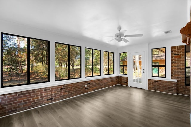 unfurnished sunroom with ceiling fan and visible vents