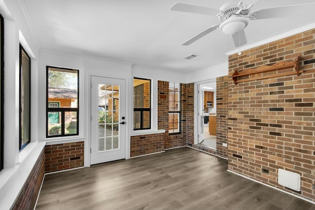 unfurnished sunroom with a ceiling fan and visible vents