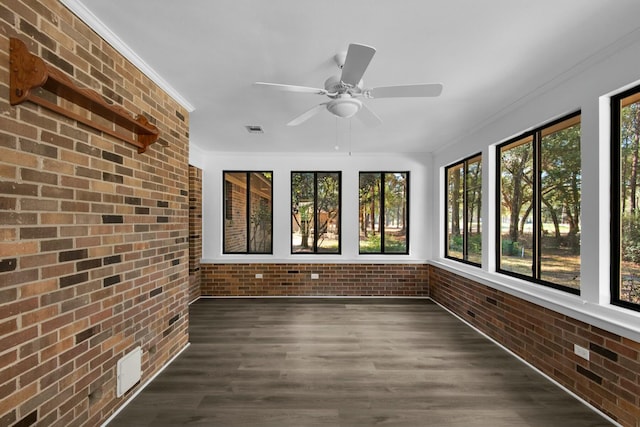 unfurnished sunroom featuring ceiling fan and visible vents