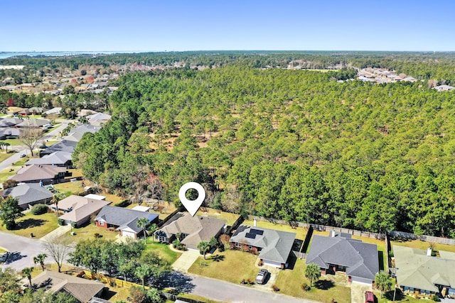 drone / aerial view with a residential view and a forest view