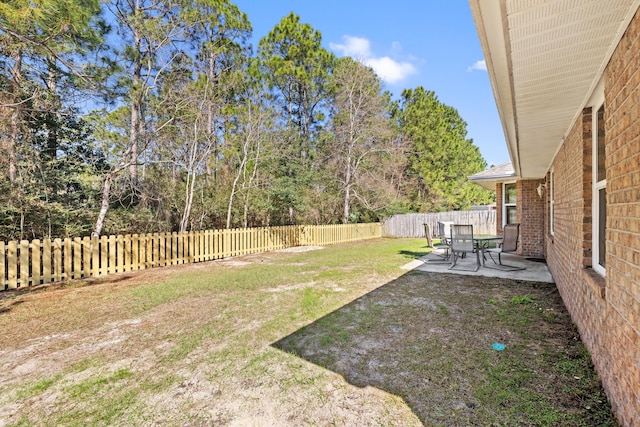 view of yard featuring a patio and a fenced backyard