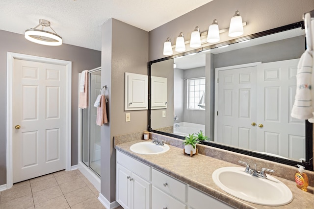 full bathroom featuring a stall shower, a sink, and tile patterned floors