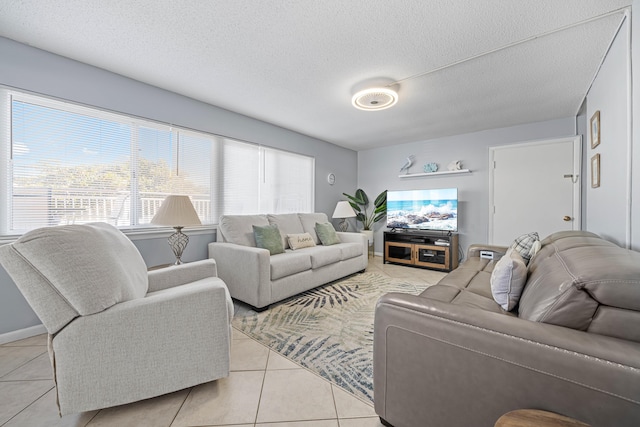 living room featuring light tile patterned flooring and a textured ceiling