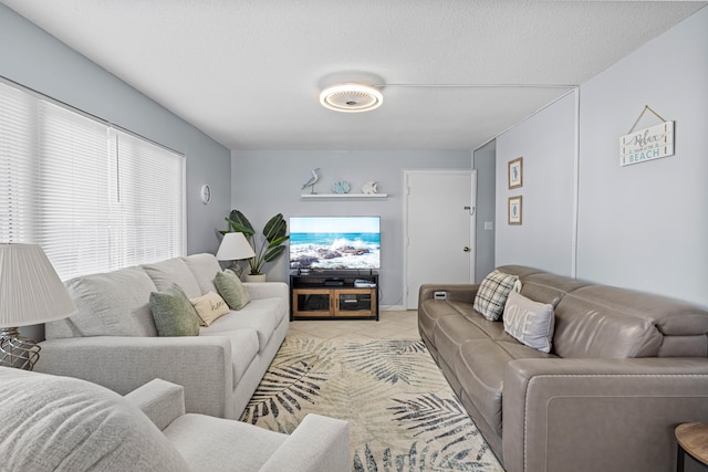 living room featuring light tile patterned flooring and a textured ceiling