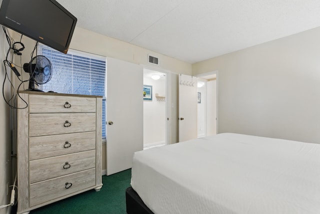 bedroom with visible vents and dark carpet