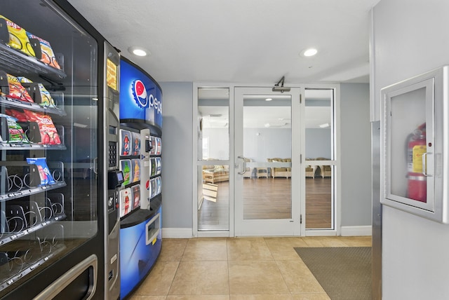 interior space with recessed lighting, baseboards, and tile patterned flooring