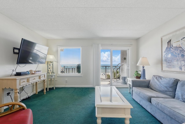 living area featuring baseboards, a textured ceiling, and carpet flooring