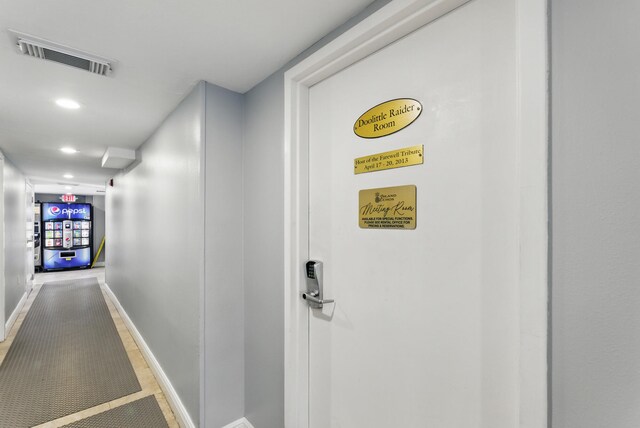 hallway with recessed lighting, visible vents, and baseboards